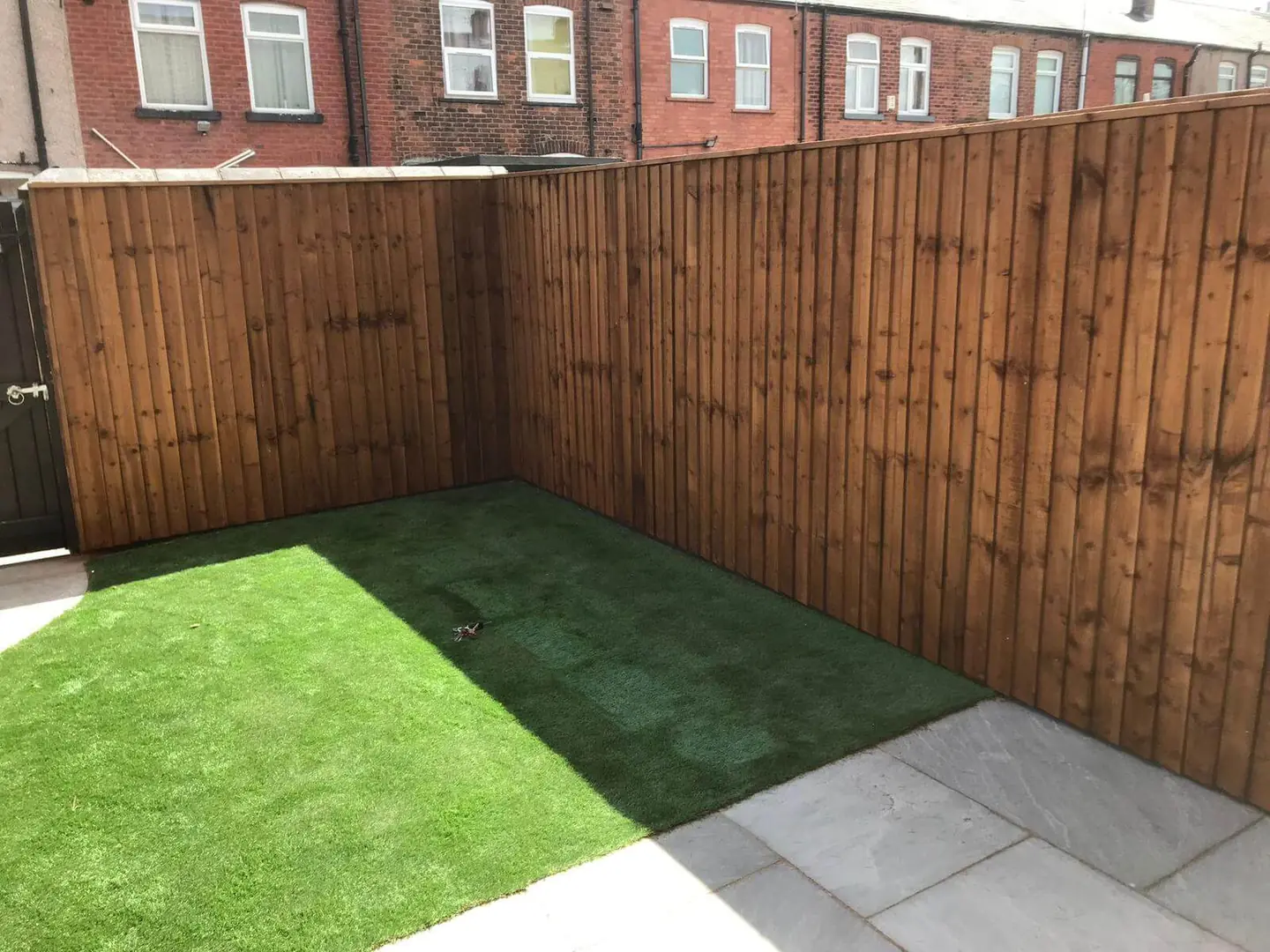 Finished closeboard timber fencing around a compact rear garden