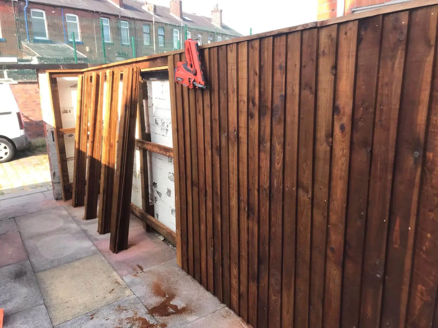 Timber boards being fitted during fence installation